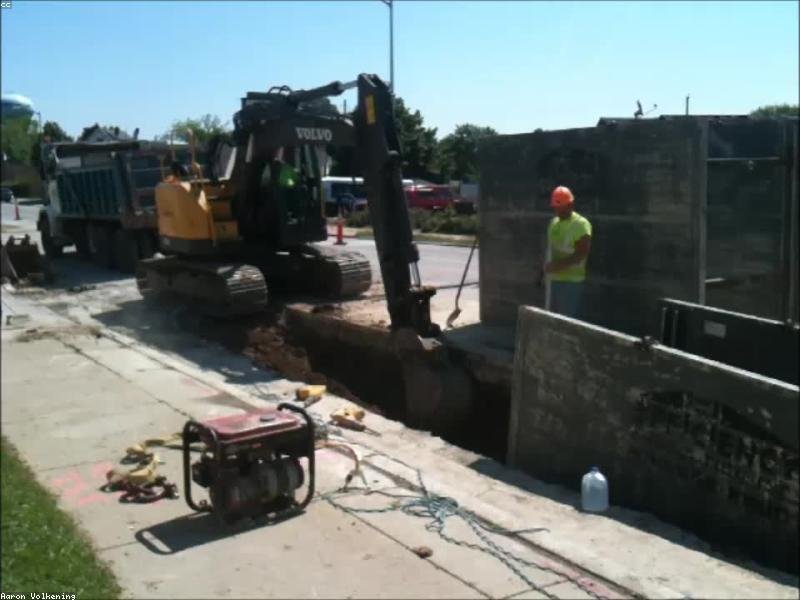 Active excavation trench beside a residential foundation